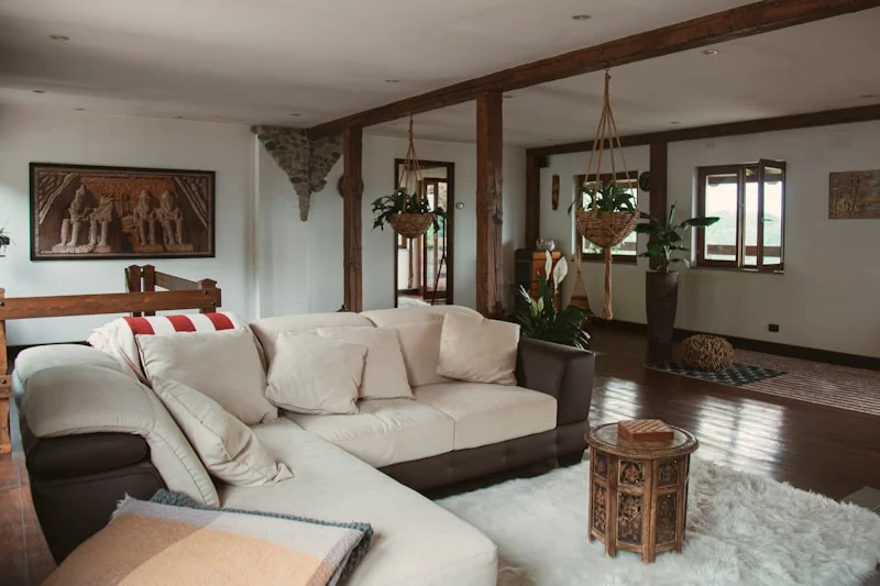 A finished living room — warm neutrals, layered texture, afternoon light
